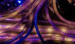 Overhead shot of multi story highways at night