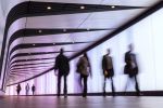 Business people Walking Along Illuminated Lightwall Corridor,